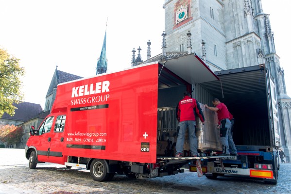 Transfering goods from an overseas container in to a small removal van in the old town of Zurich