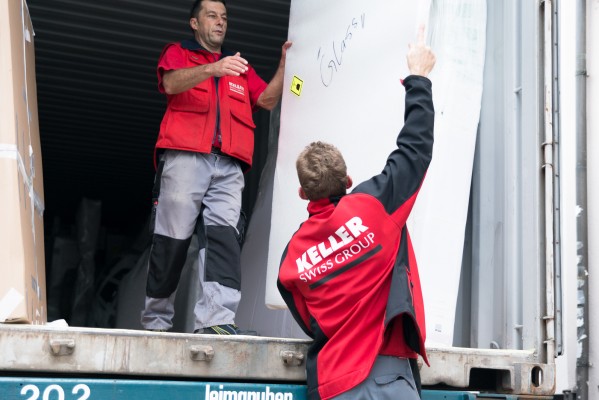 Two Keller Swiss Group packers load an overseas container
